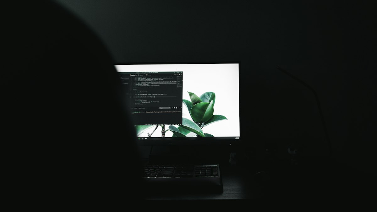 Monitor showing code in a dark room